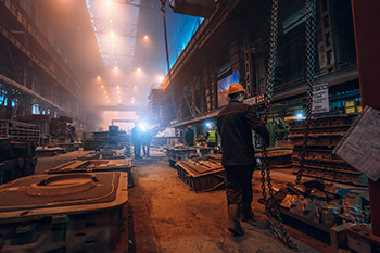 foundry workers are pictured in high heat environment