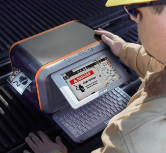 A worker ion a worksite  using Labelforge Pro on a Toro Max Industrial Label Printer