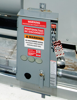 Electrical panel with OSHA lockout/tagout label and warning signs for safe maintenance.