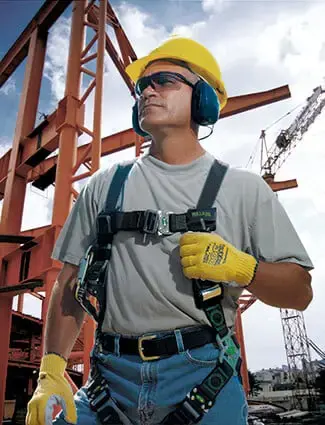 Worker on a jobsite wearing a variety of PPE