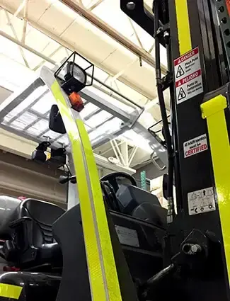 Bilingual labels on forklift alert to danger of pinch points