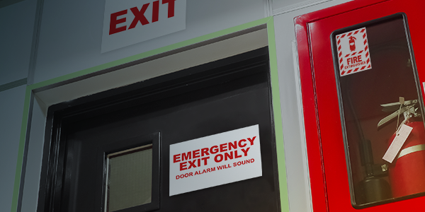 Emergency exit door with a fire extinguisher cabinet and usage instructions.