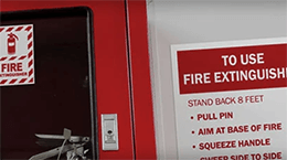 Fire extinguisher station with clear signage and instructions for use, supporting OSHA compliance in workplace fire safety.