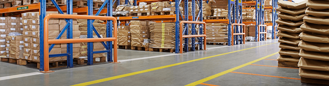 A warehouse organized with floor marking tape and walkway lines marking aisles and safety areas