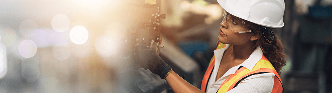 Woman performing maintenance on factory equipment