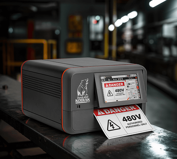 A DuraLabel Kodiak Max Printer printing out a DANGER sign to highlight electrical hazards.