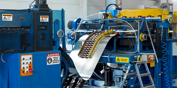 Manufacturing line with standardized labels and signs aligned with OSHA labeling requirements and consistent facility visual systems.