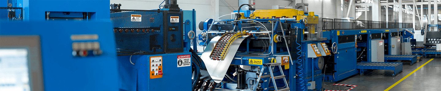 Manufacturing line with standardized labels and signs aligned with OSHA labeling requirements and consistent facility visual systems.