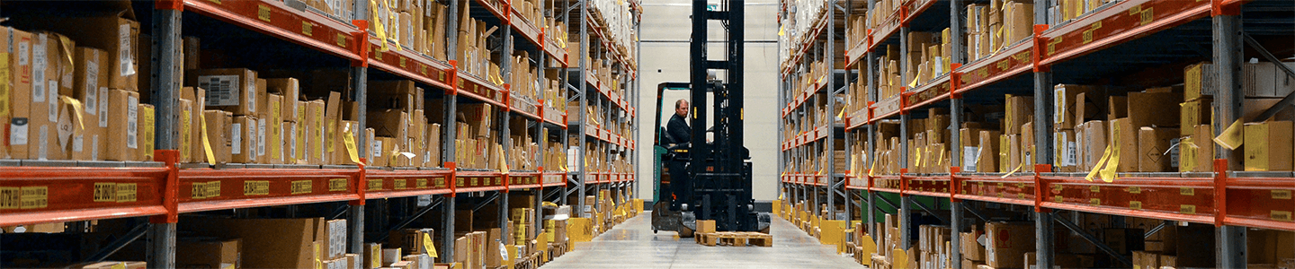 Warehouse shelves and bins labeled with barcodes and durable identification labels
