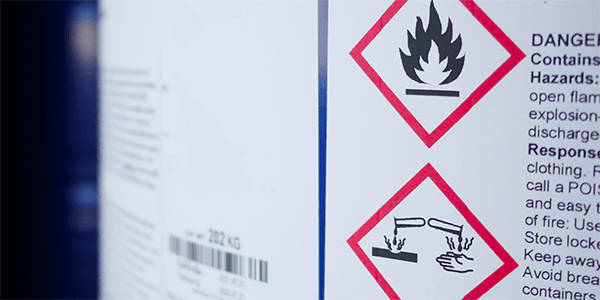 Close up image of a GHS label applied to a chemical drum