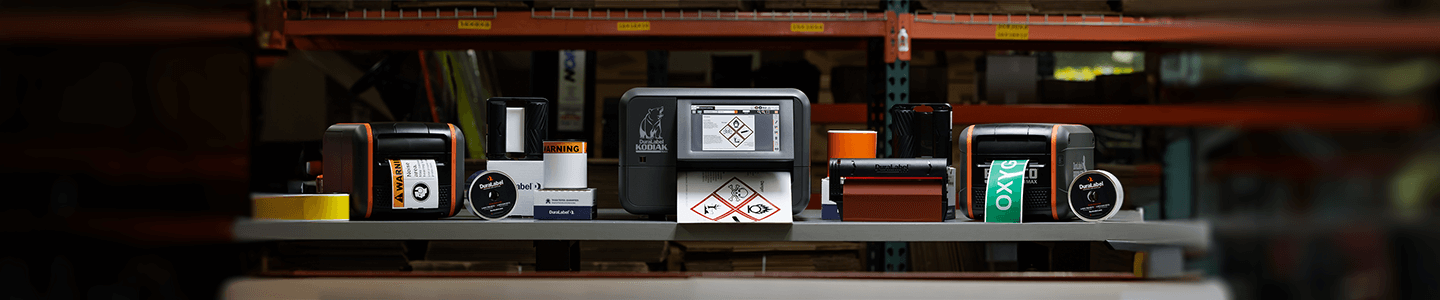 DuraLabel industrial sign and label systems on a workbench.