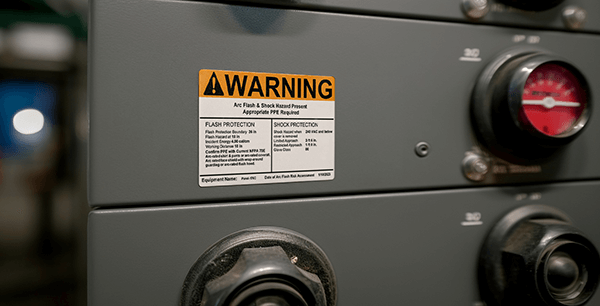 Close-up of arc flash label showing voltage, PPE level, and boundary info