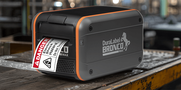 Bronco Max industrial label maker printing a danger label in a manufacturing environment.