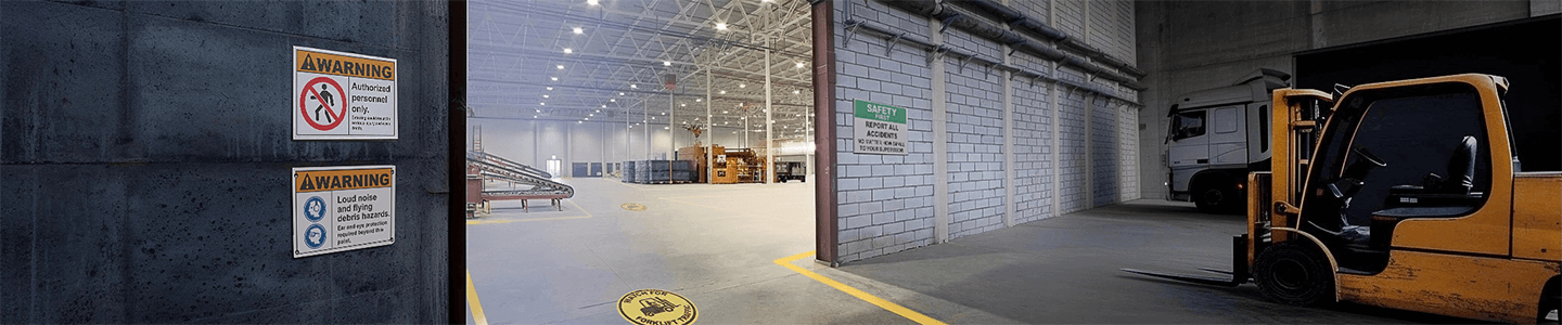 Floor marking directing forklift safely through warehouse door with warning sign