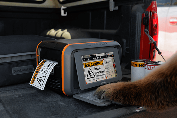 DuraLabel Toro Max printing compliant safety labels to replace outdated workplace signage during an end-of-year signage audit.