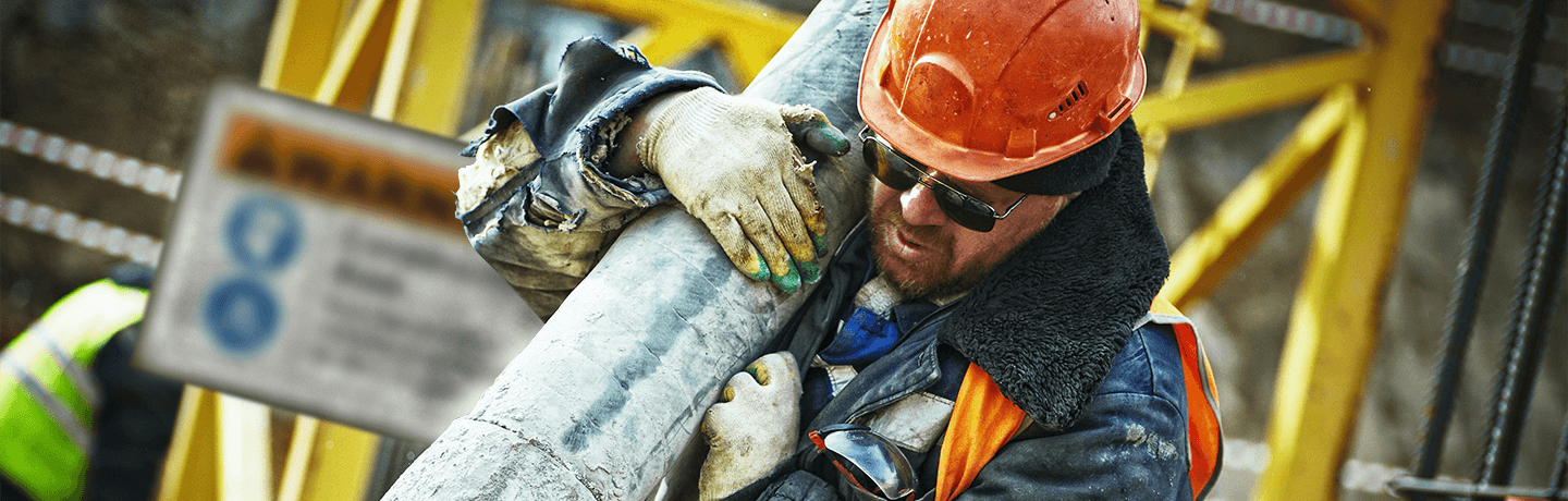 A gritty construction worker with a pipe on his shoulder, there is an OSHA sign behind him