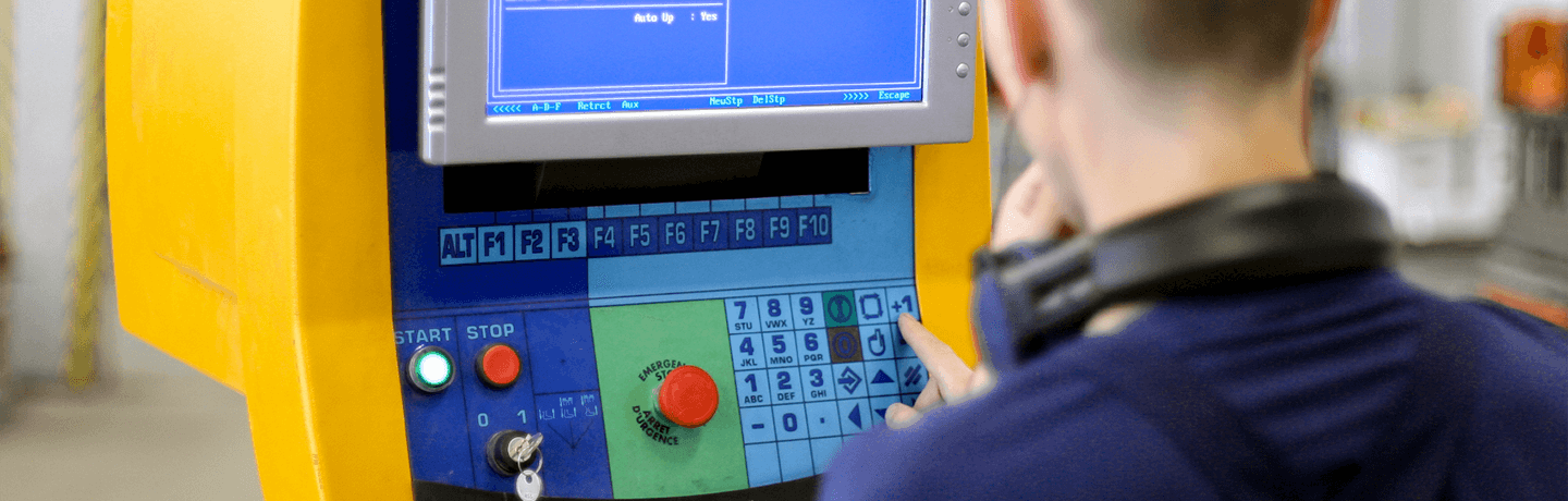 A worker pressing buttons on a simple control panel