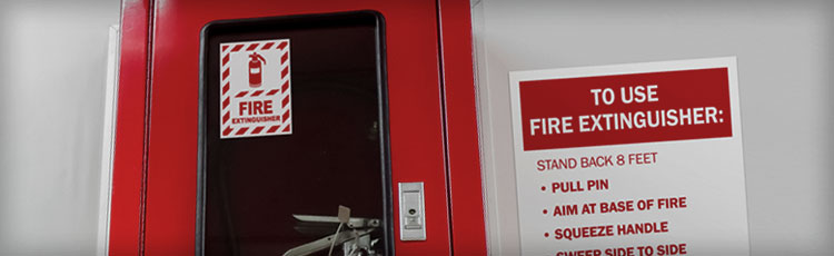 Fire extinguisher station with clear signage and instructions for use, supporting OSHA compliance in workplace fire safety.