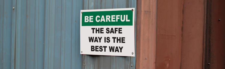 A safety sign posted on a worksite: Be Careful - The safe way is the best way