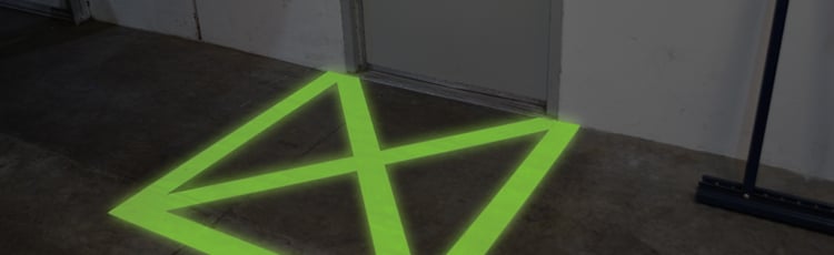 Glow-in-the-dark floor marking tape shown in low light