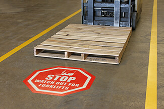 Floor sign warns to watch for forklifts