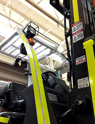 Bilingual signs on a forklift inform workers.