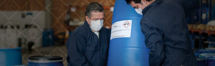 Workers Moving a Chemical Barrel