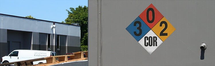 NFPA 704 hazard diamond posted on an industrial building, showing fire, health, and reactivity ratings for HazCom chemical hazard identification.