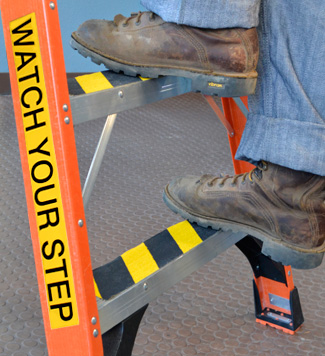 Ladder label reminds workers to watch step.