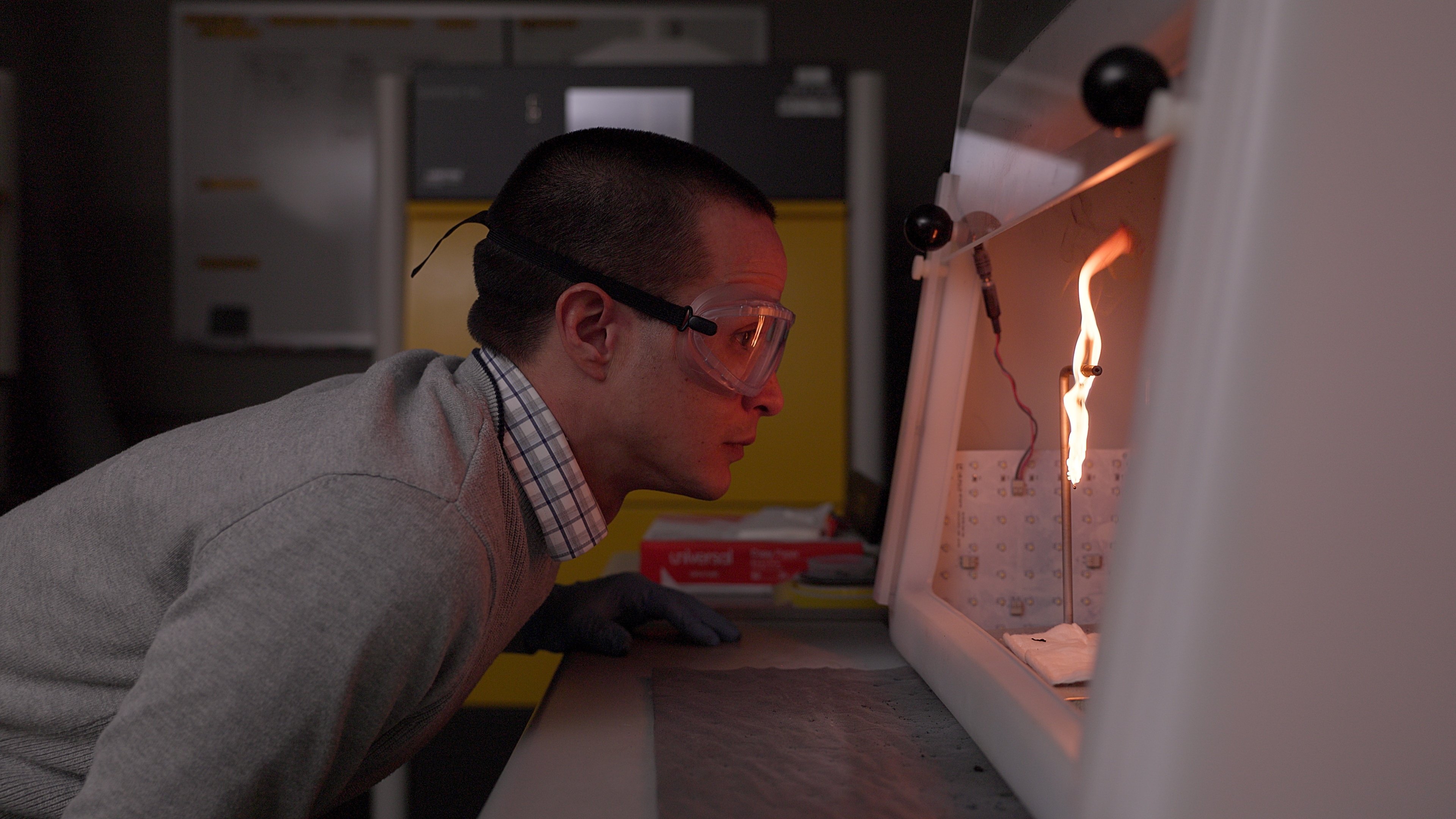 An engineer monitors a weather/heat though-tested process 