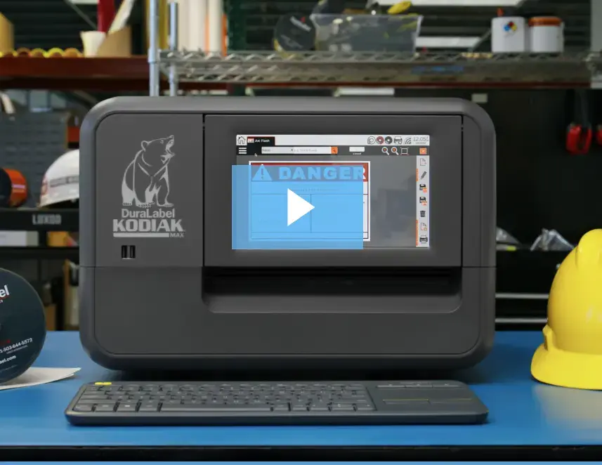 A Kodiak Max is on and ready to print custom signs and labels.