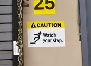 Slip prevention caution sign posted on a wall.